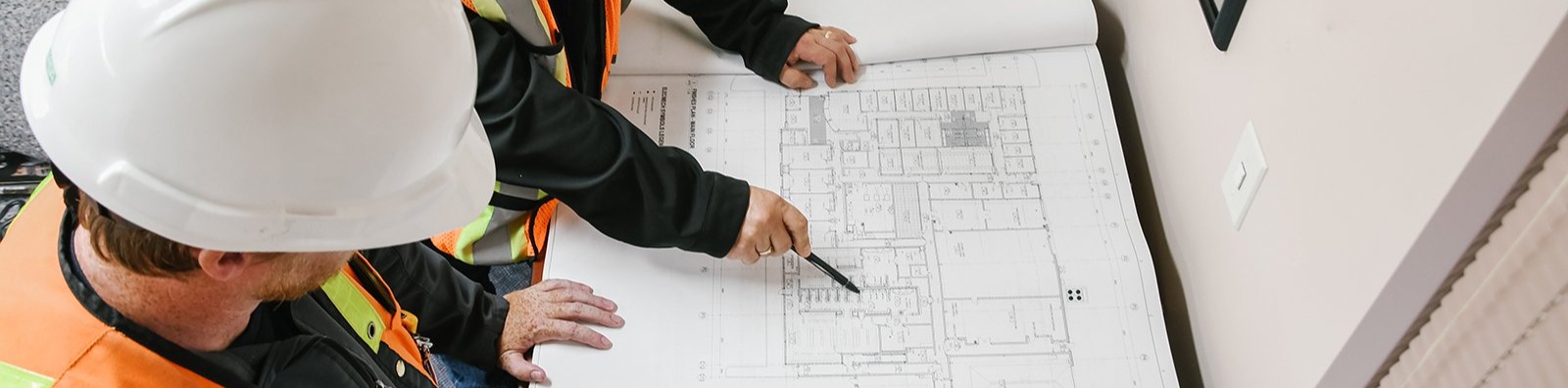 two people looking at construction plans
