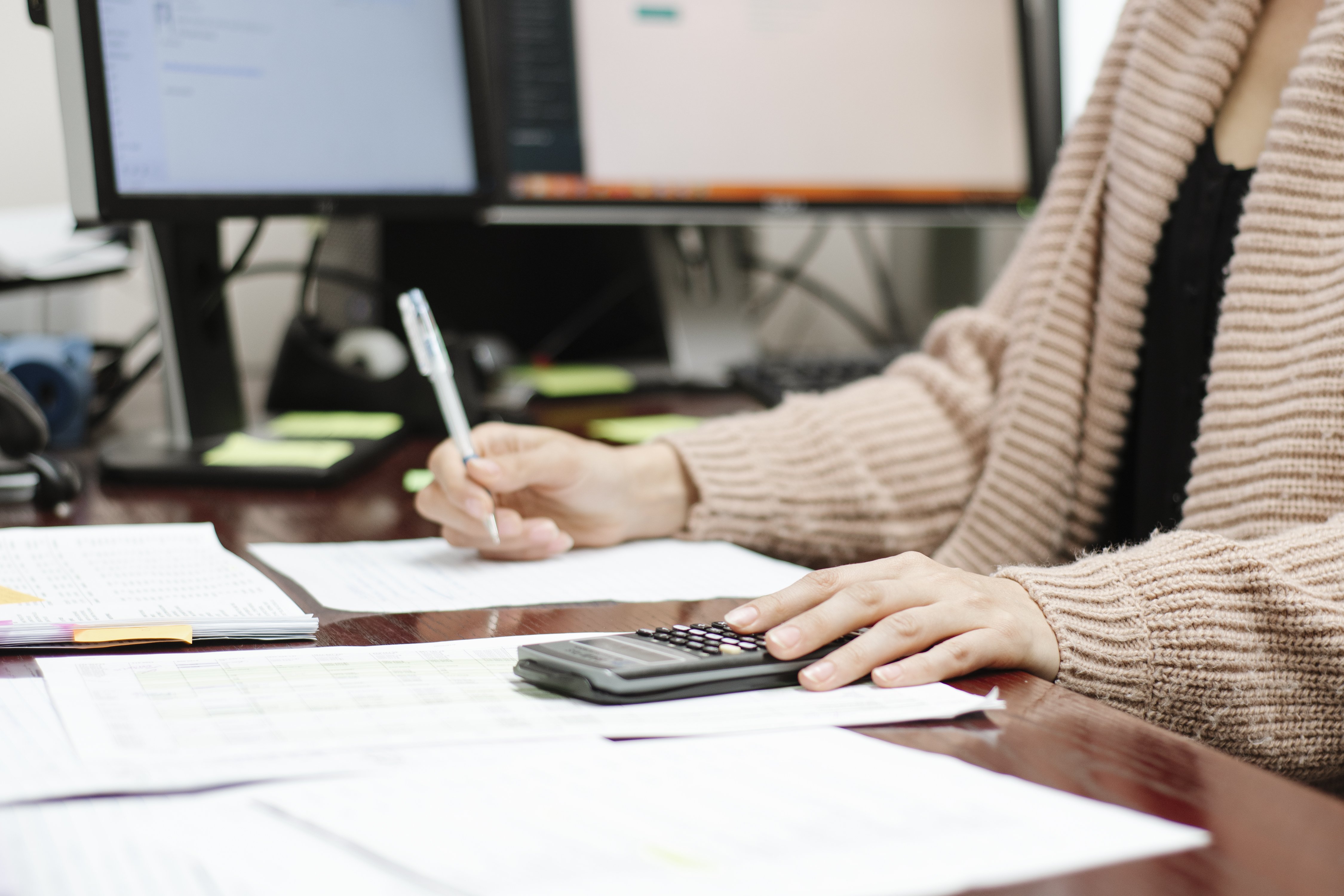 Someone using a calculator at a desk