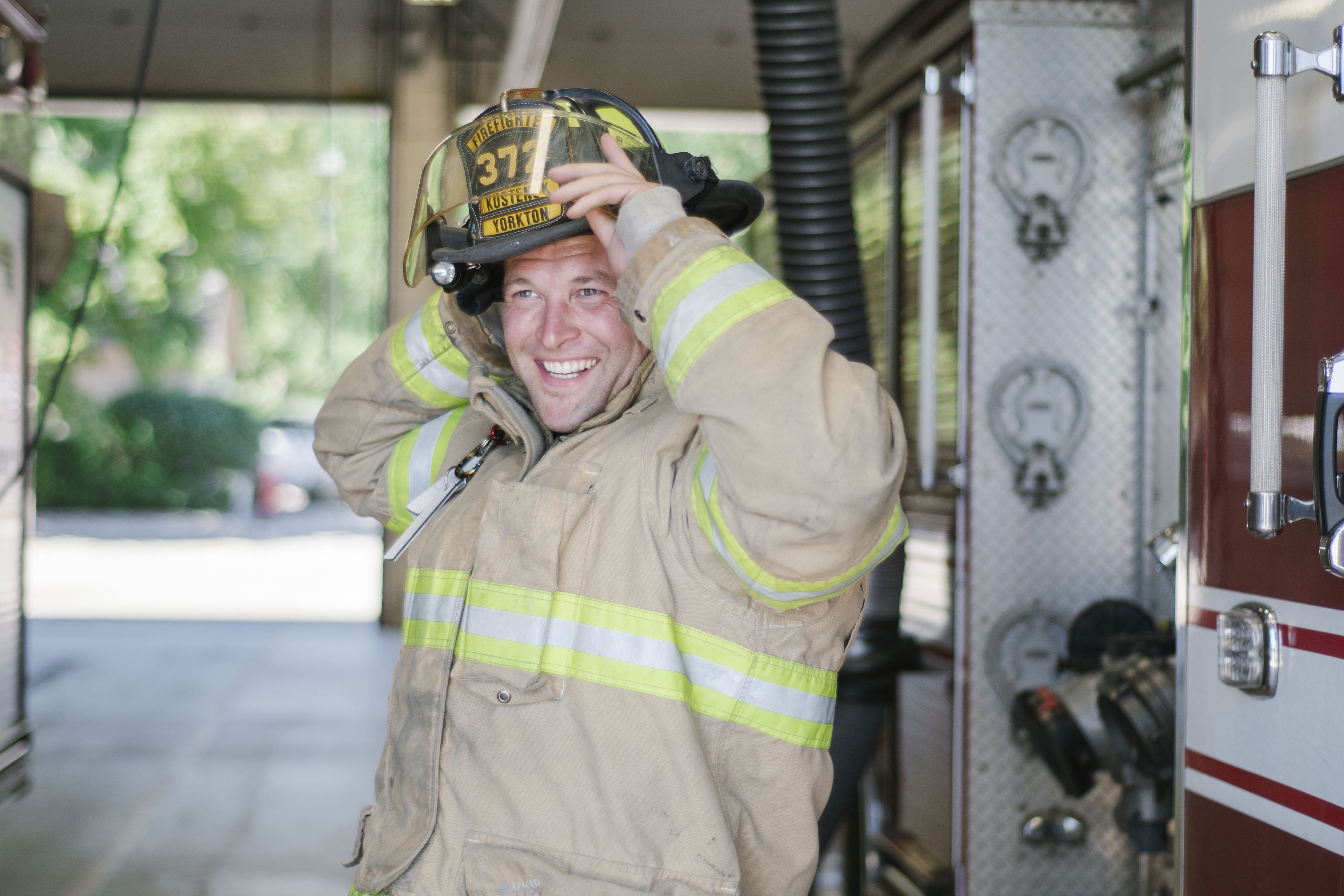 fire man putting helmet on