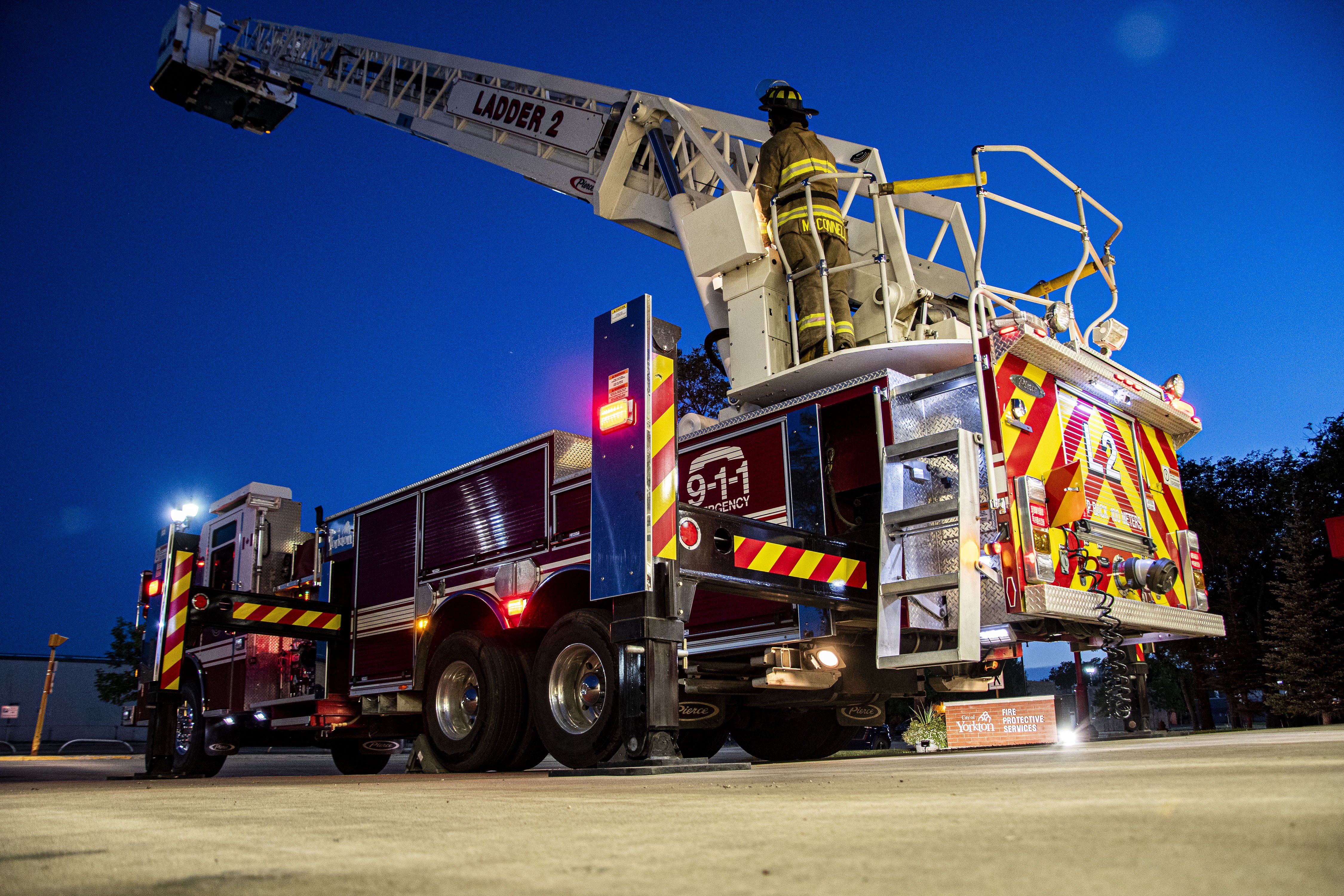 firefighters on the fire truck ladder