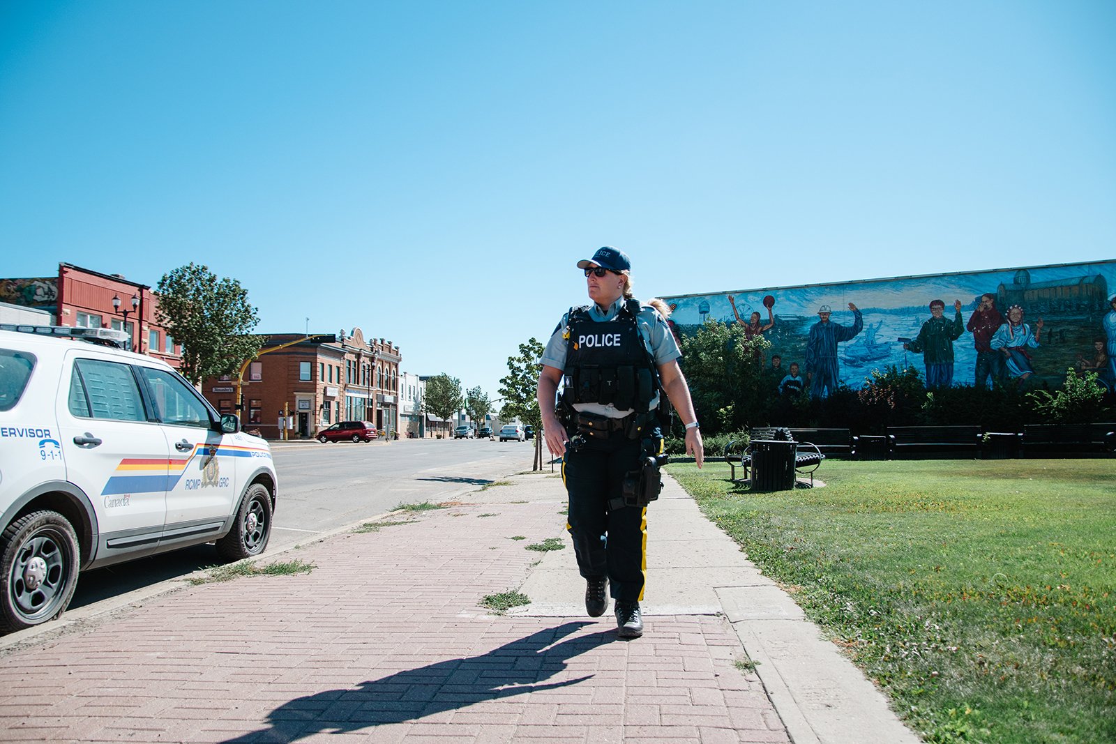 police walking down sidewalk