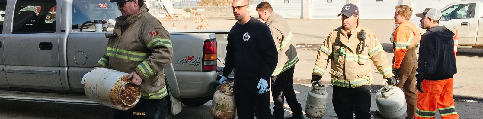 guys lifting propane tanks out of truck