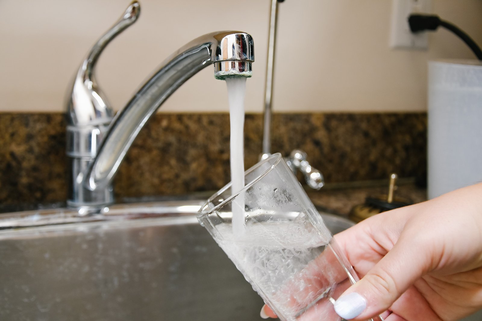 pouring water into glass