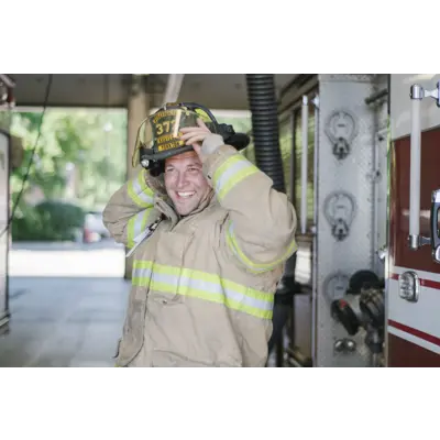 fire man putting helmet on